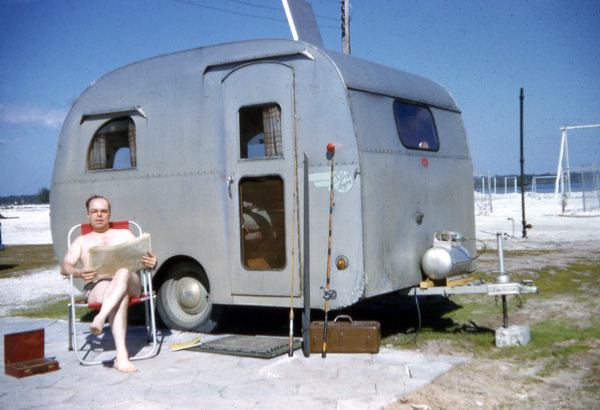 Sitting with travel trailer at St. Petersburg Beach, by The State Library and Archives of Florida